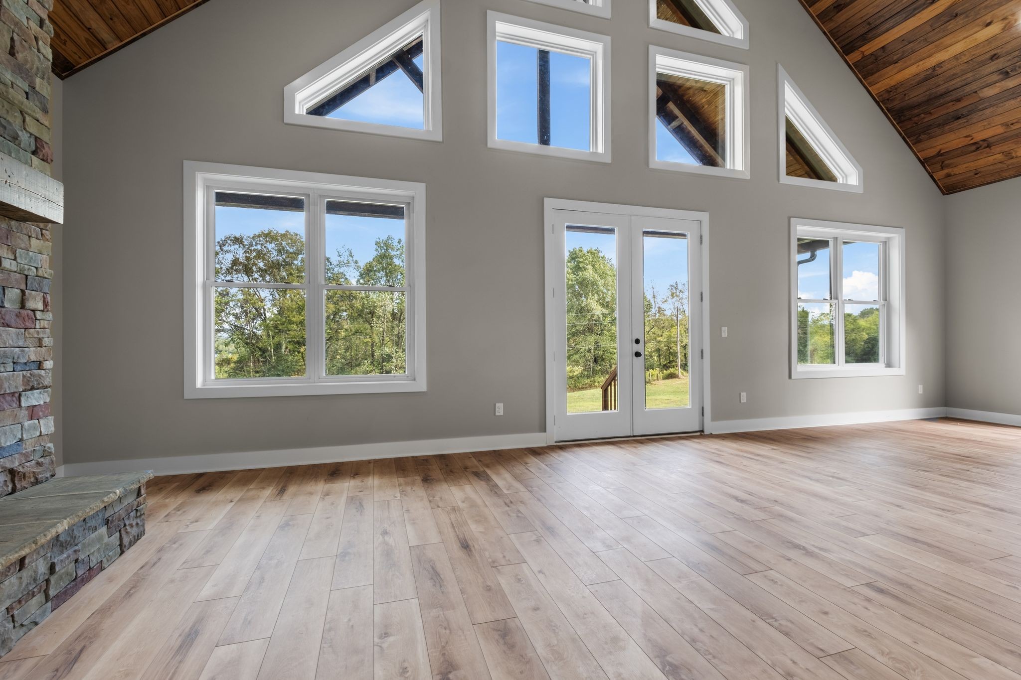 672 Sullivan Bend Road Elmwood, TN 38560 - Photo 14 of 39 an empty room with wooden floor and windows