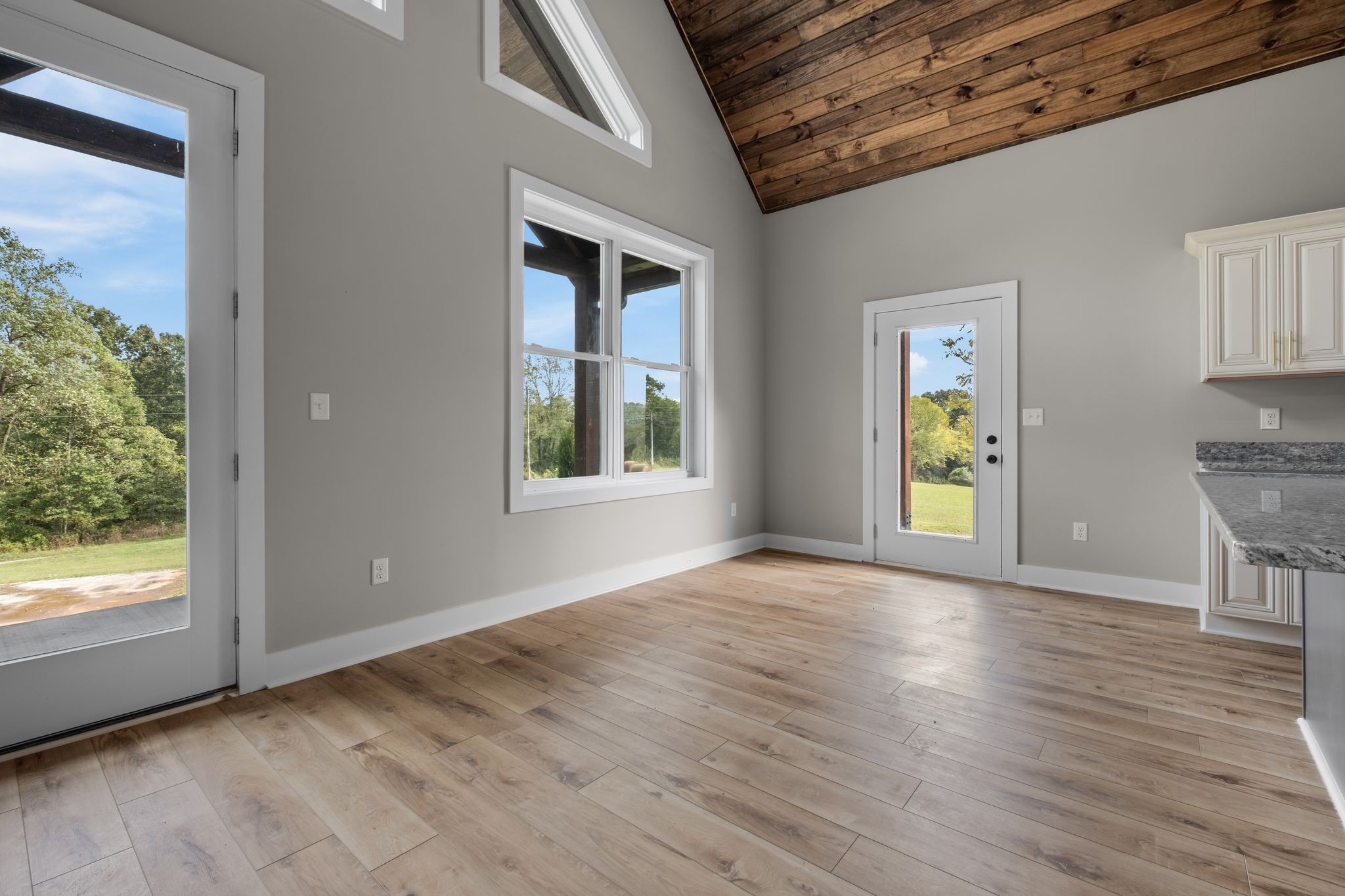 672 Sullivan Bend Road Elmwood, TN 38560 - Photo 15 of 39 en empty room with window and wooden floor