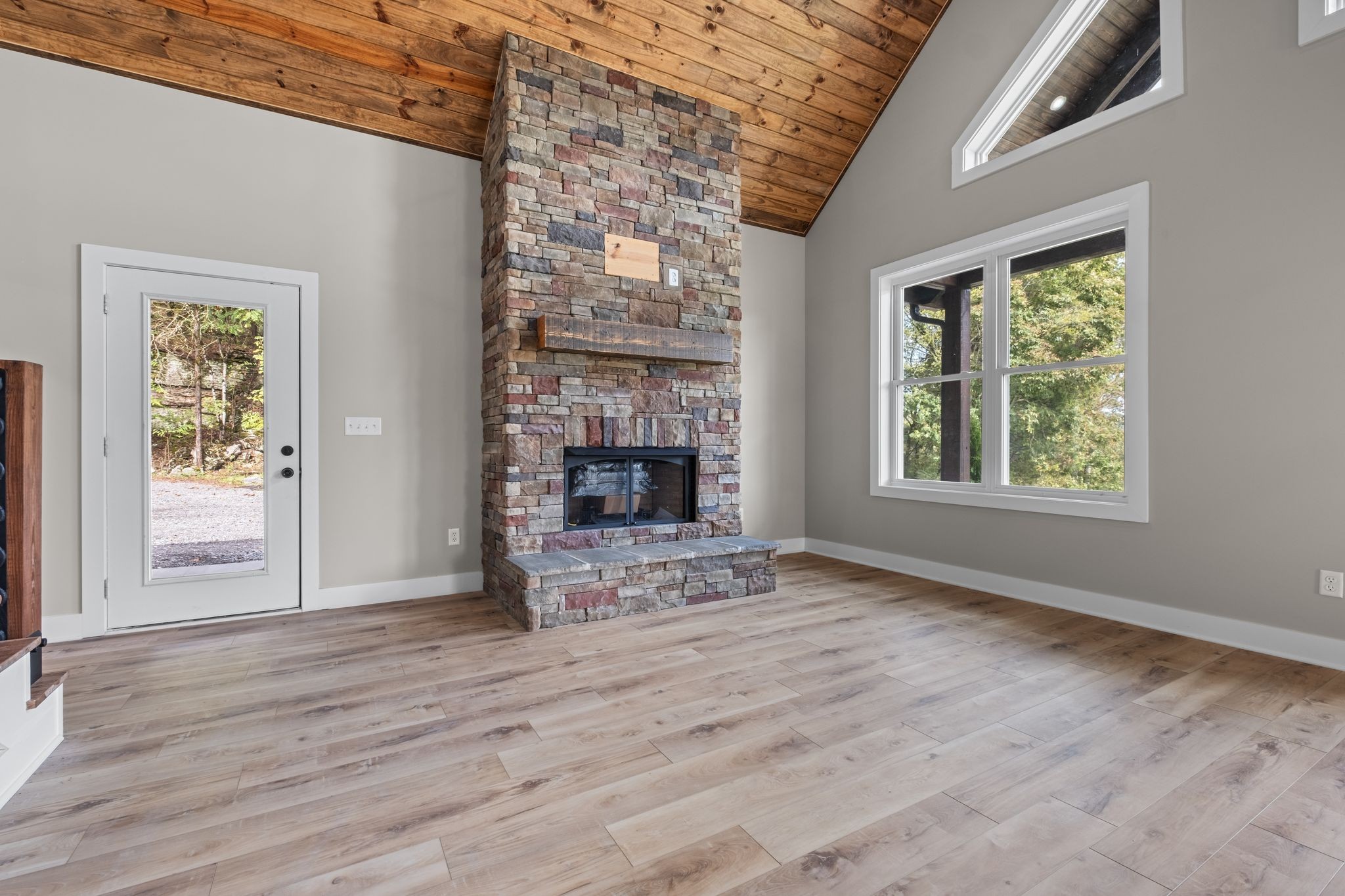 672 Sullivan Bend Road Elmwood, TN 38560 - Photo 16 of 39 a view of an empty room with wooden floor and a window