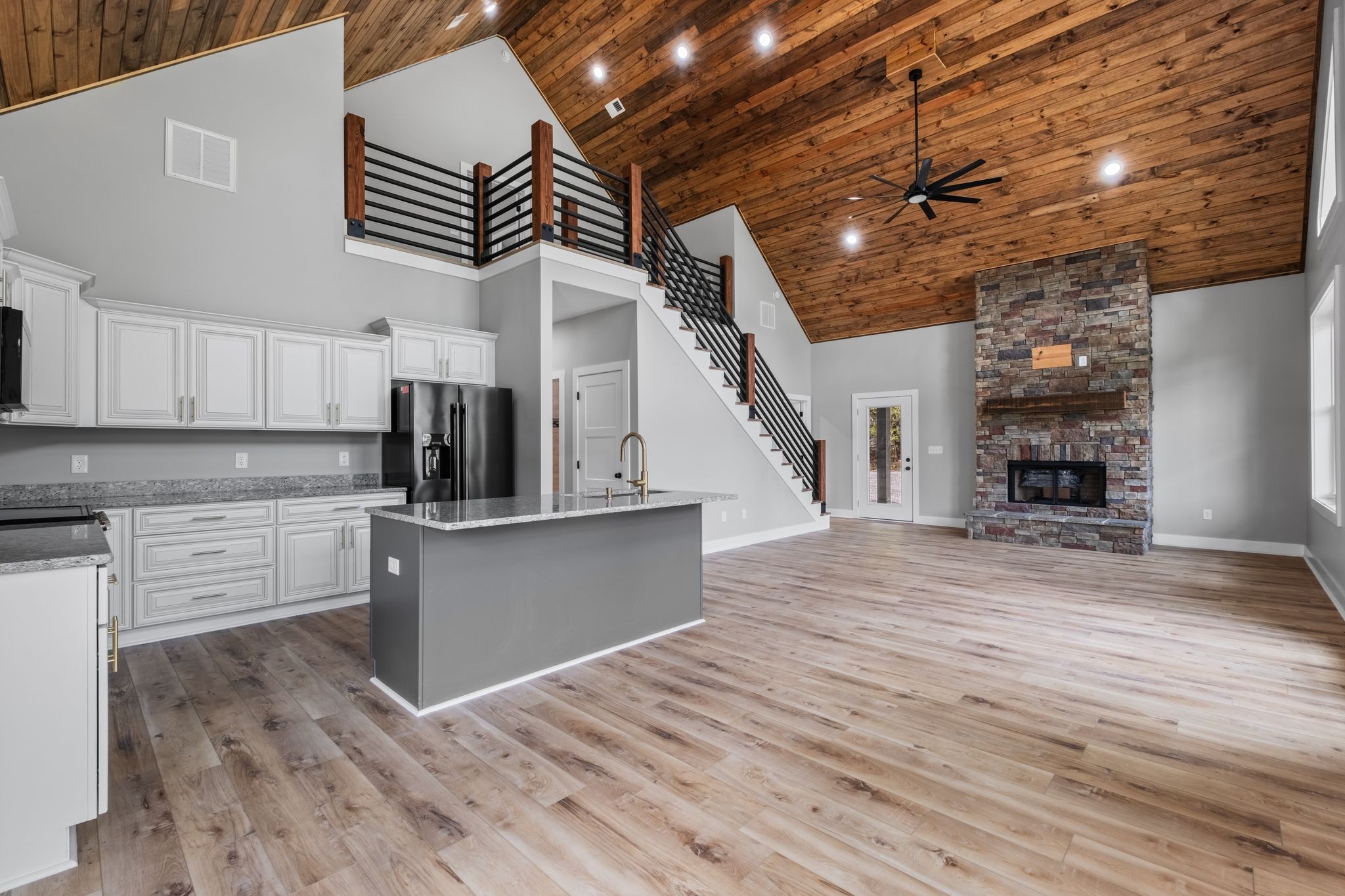672 Sullivan Bend Road Elmwood, TN 38560 - Photo 17 of 39 a kitchen with stainless steel appliances granite countertop a refrigerator a stove and a wooden floors