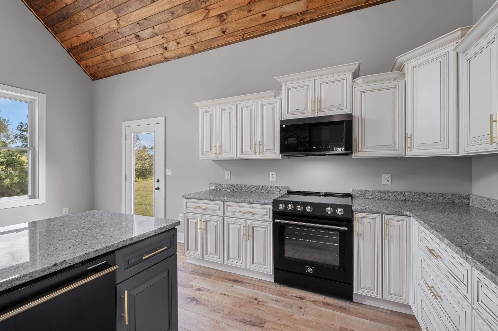672 Sullivan Bend Road Elmwood, TN 38560 - Photo 18 of 39 a kitchen with granite countertop a stove sink and microwave