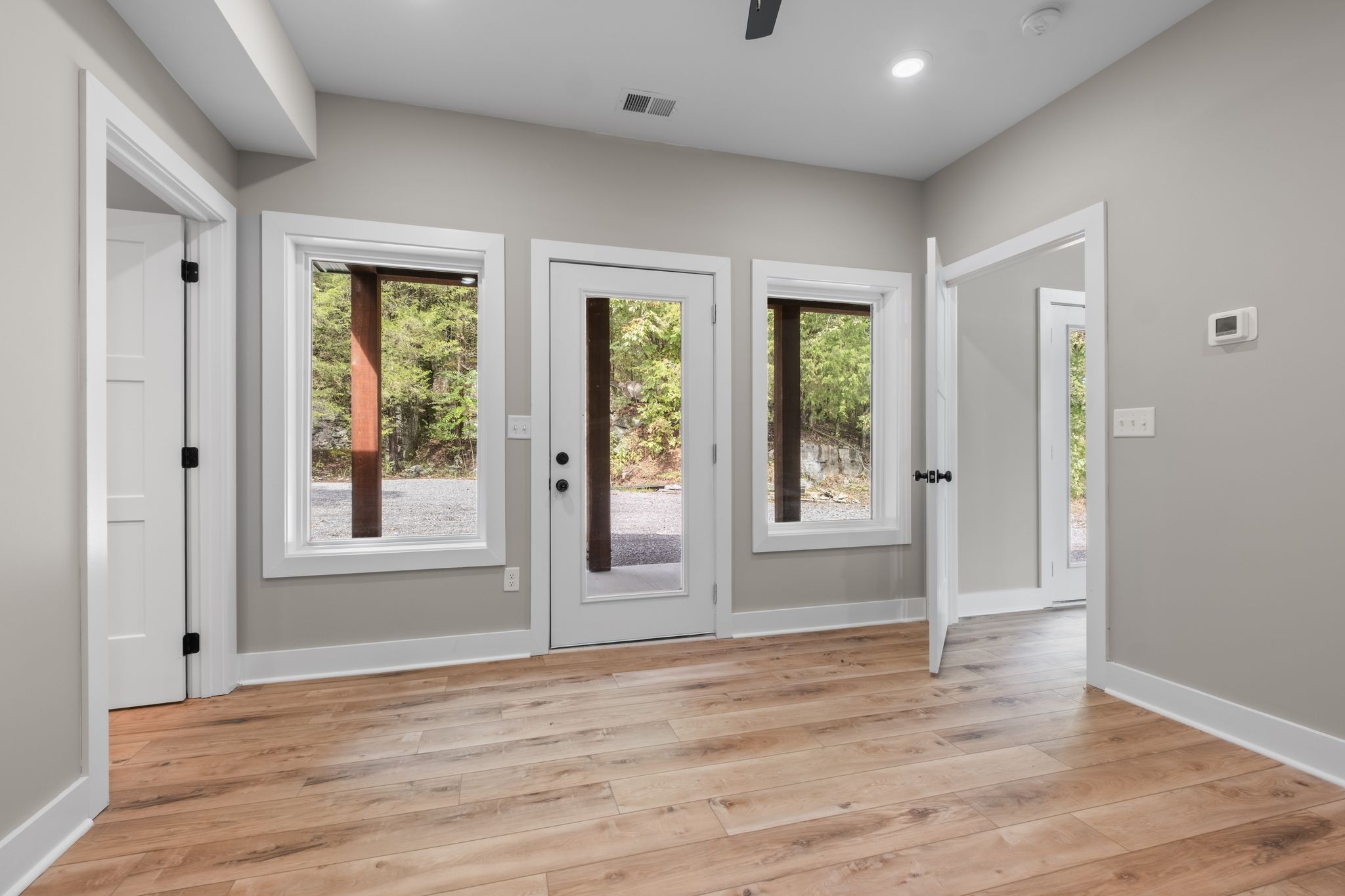 672 Sullivan Bend Road Elmwood, TN 38560 - Photo 20 of 39 a view of an empty room with wooden floor and a window