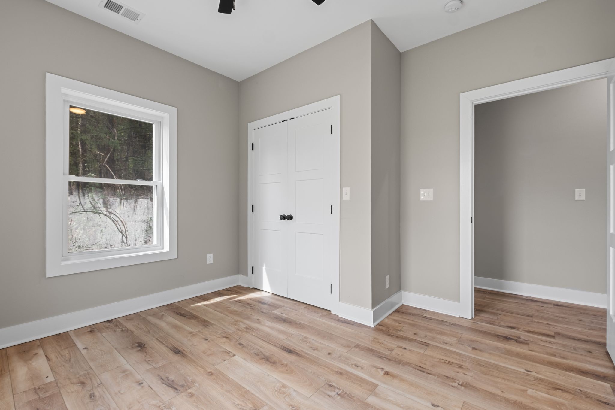 672 Sullivan Bend Road Elmwood, TN 38560 - Photo 26 of 39 an empty room with wooden floor and windows