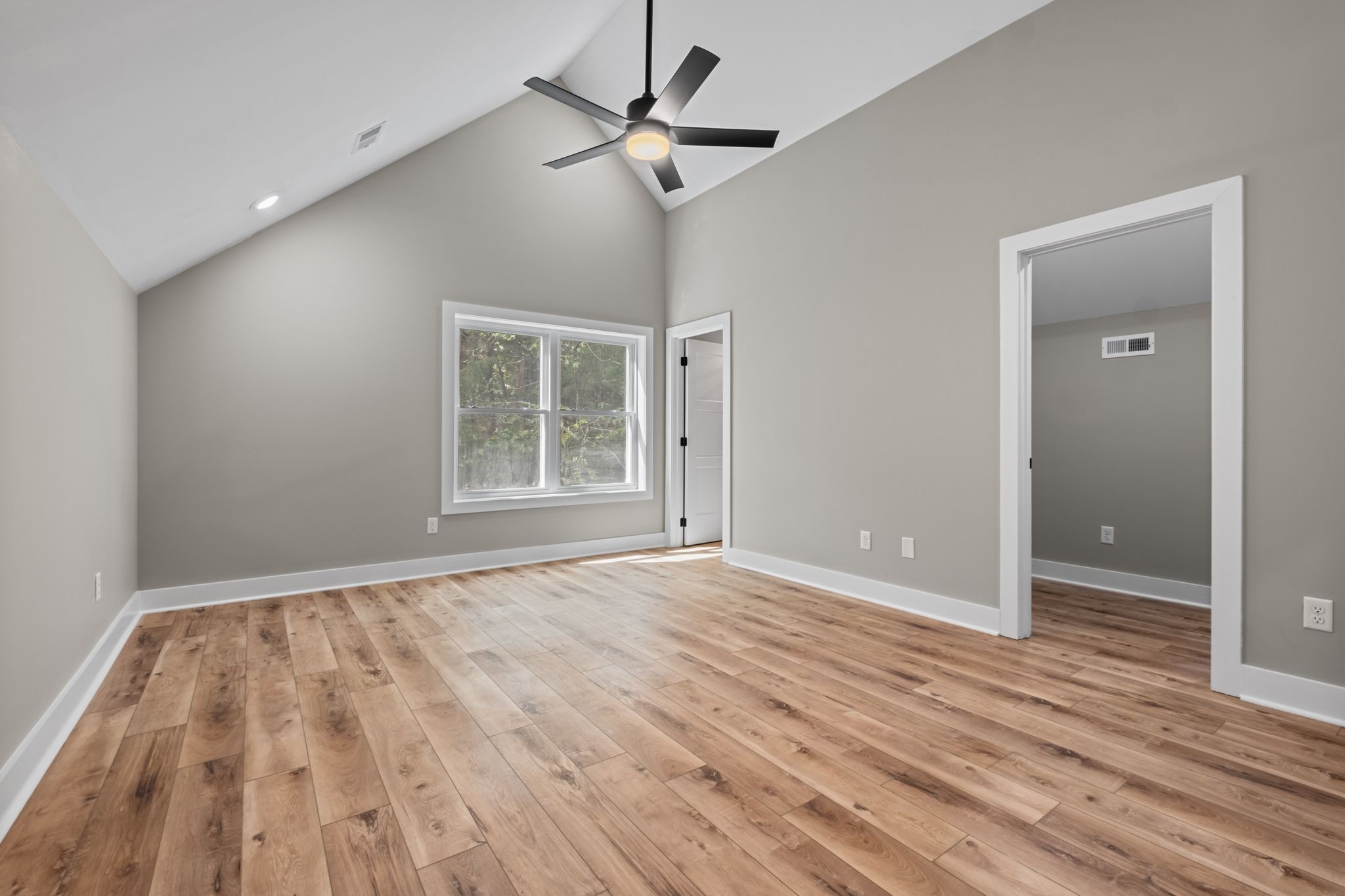 672 Sullivan Bend Road Elmwood, TN 38560 - Photo 30 of 39 an empty room with wooden floor ceiling fan and windows