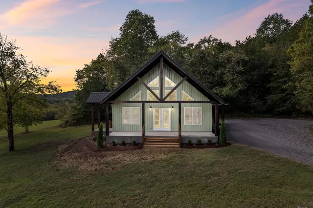 a view of backyard of house with green space