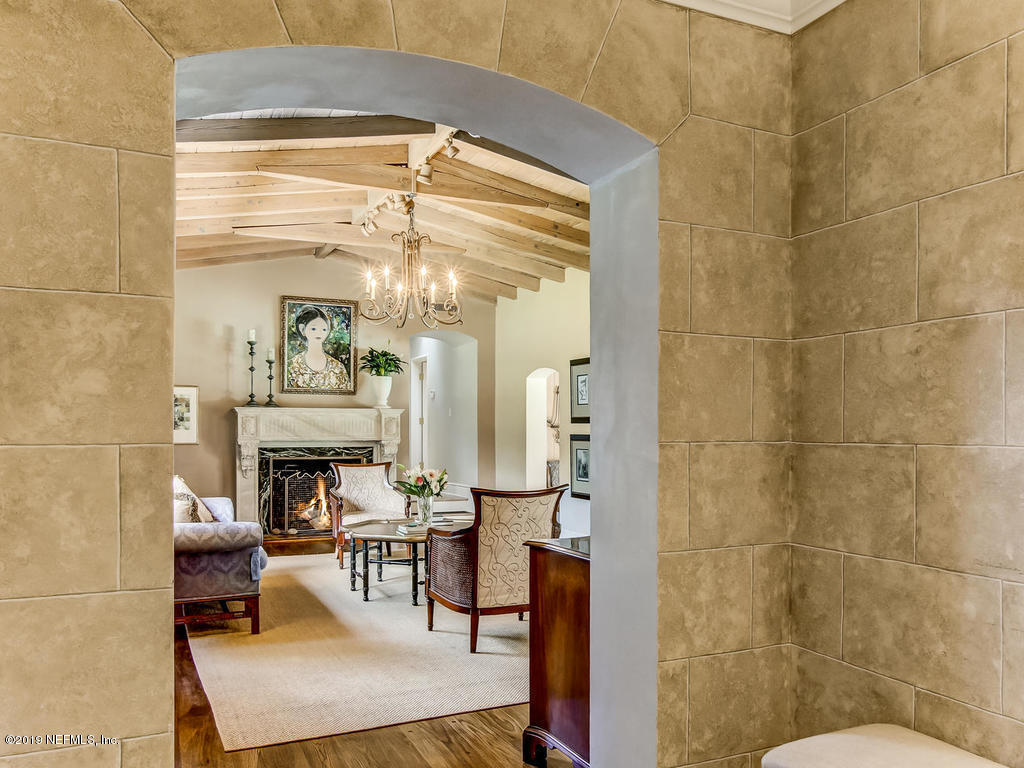 1036 Elder Lane Jacksonville, FL 32207 - Photo 13 of 79 a living room with couches and a dining table with a mirror