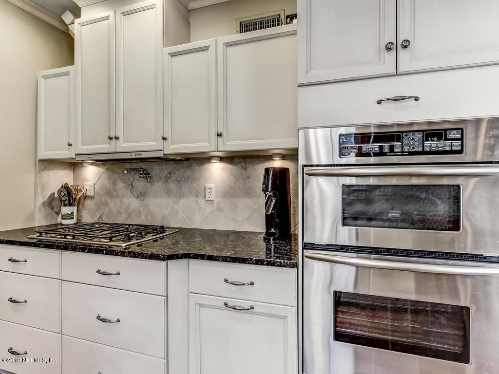 1036 Elder Lane Jacksonville, FL 32207 - Photo 24 of 79 a kitchen with stainless steel appliances granite countertop white cabinets and a stove a oven with white countertops
