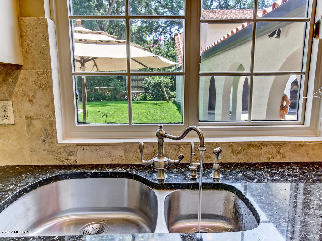 1036 Elder Lane Jacksonville, FL 32207 - Photo 26 of 79 a kitchen with a sink a counter top space and cabinets
