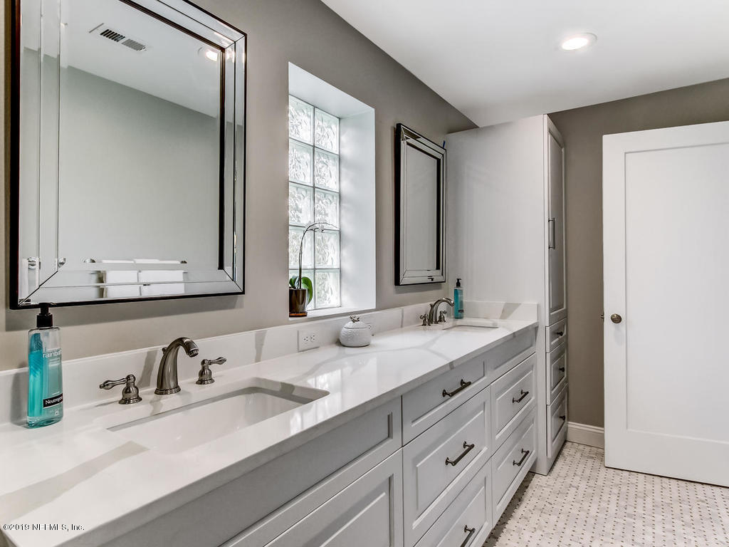 1036 Elder Lane Jacksonville, FL 32207 - Photo 51 of 79 a bathroom with double vanity sink a mirror and a window