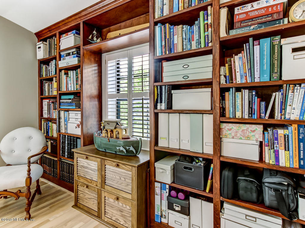1036 Elder Lane Jacksonville, FL 32207 - Photo 54 of 79 a living room with bookshelf and a window