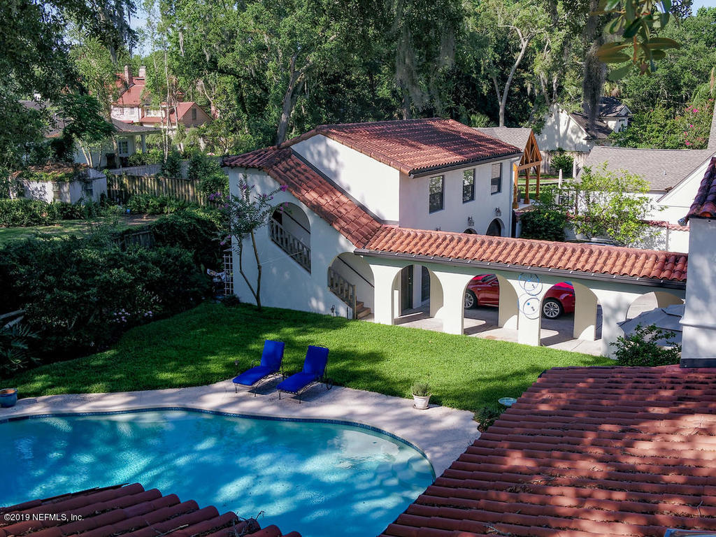 1036 Elder Lane Jacksonville, FL 32207 - Photo 62 of 79 a view of a house with a yard and potted plants