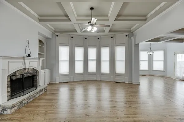 a kitchen with stainless steel appliances granite countertop a stove and a wooden floors