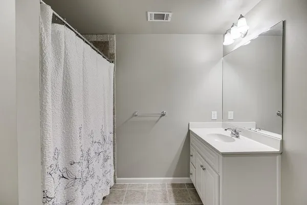 a view of an empty room with a ceiling fan