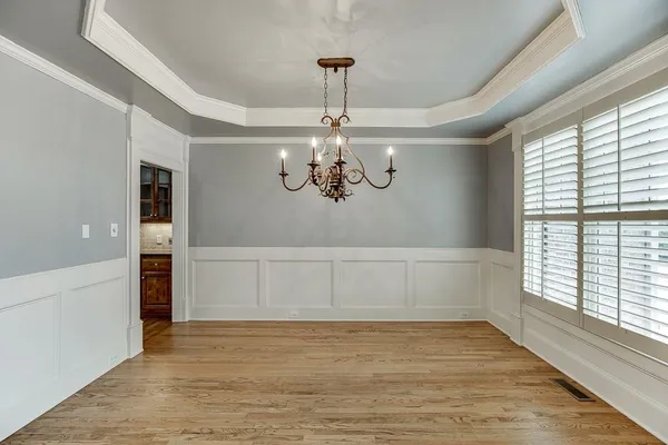 a view of a livingroom with hardwood floor and a ceiling fan