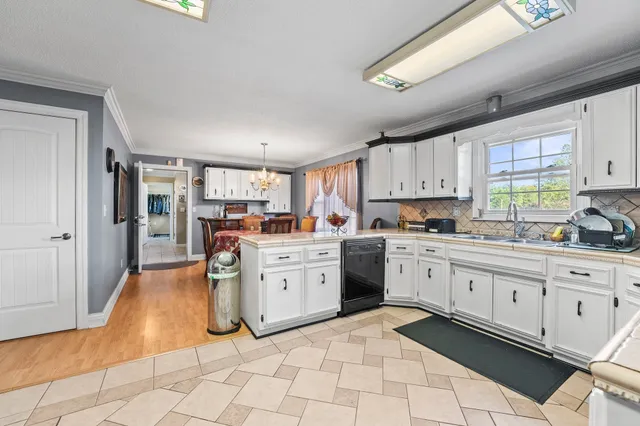 a kitchen with stainless steel appliances granite countertop a sink and cabinets