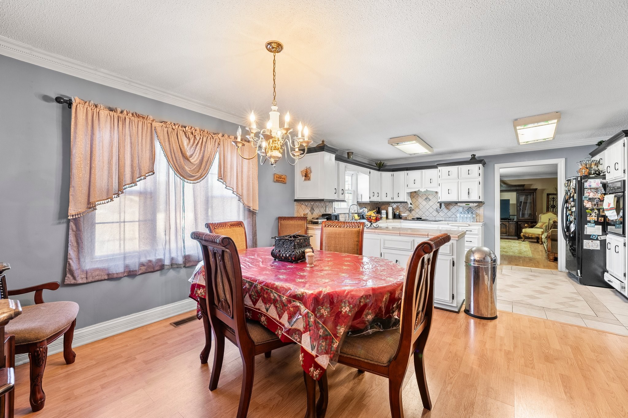 104 12 Oaks Road Tullahoma, TN 37388 - Photo 17 of 41 a dining room with furniture a chandelier and wooden floor