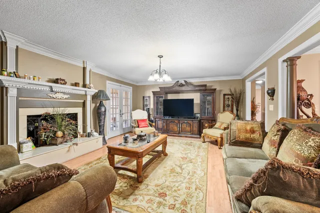 a living room with furniture a fireplace and a flat screen tv