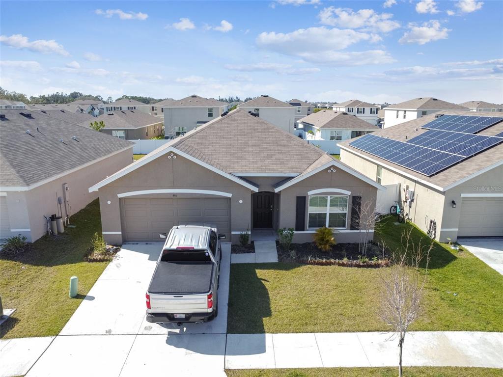 446 Calico Scallop Street Ruskin, FL 33570 - Photo 1 of 1 a aerial view of a house with a garden and plants