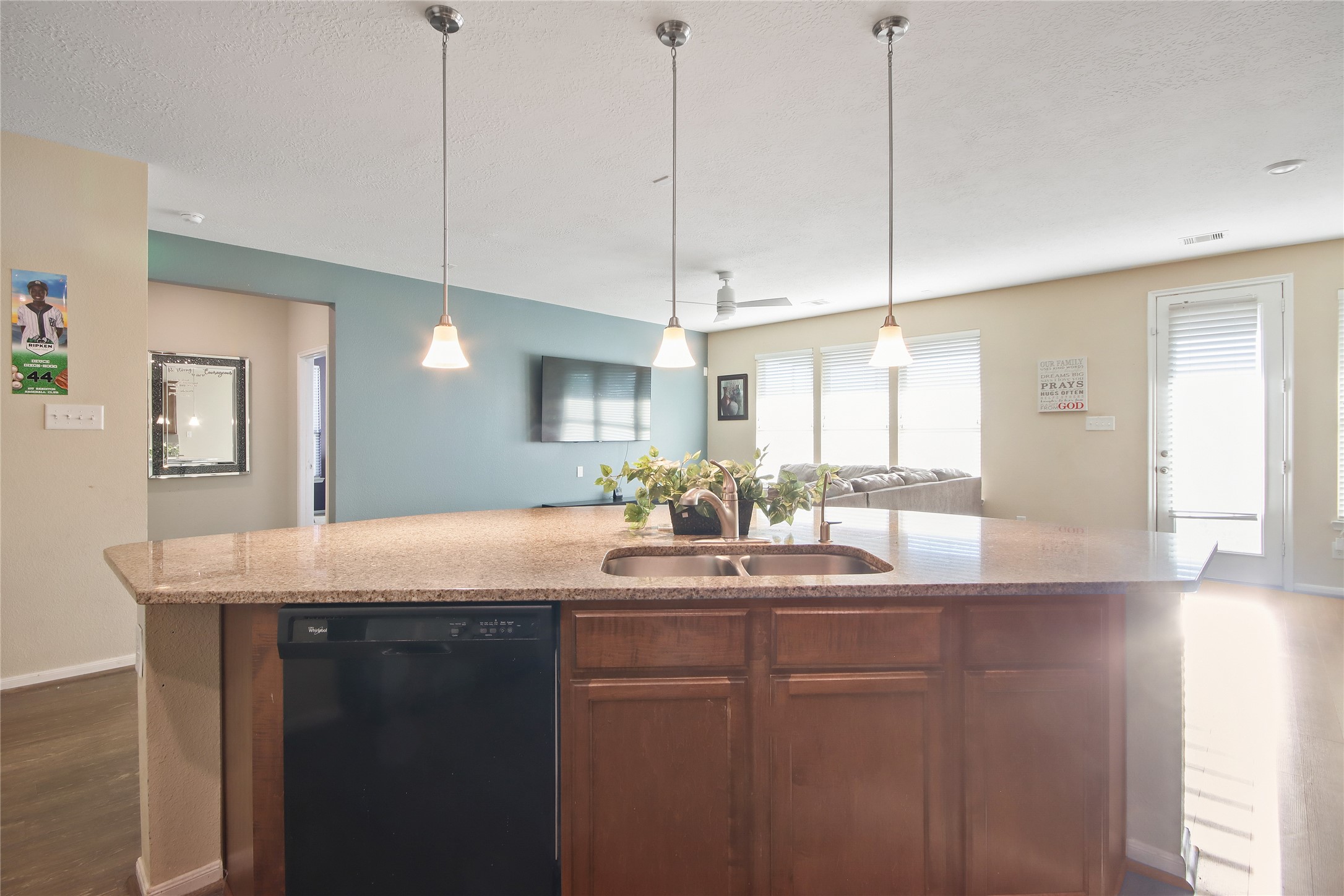 20522 Heath House Drive Porter, TX 77365 - Photo 11 of 16 a kitchen with kitchen island granite countertop a sink a counter top space and living room view