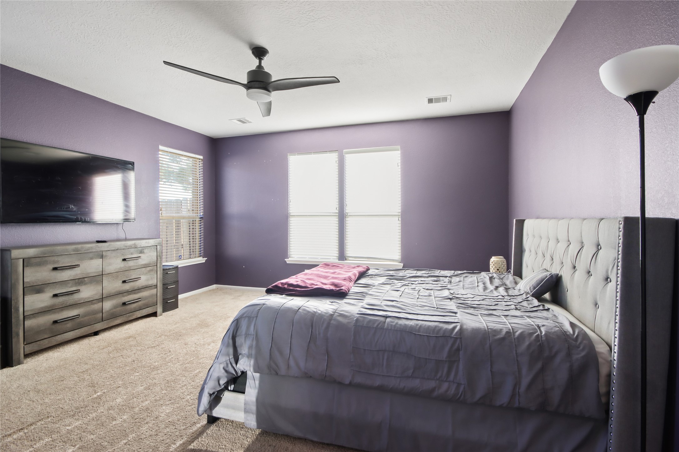20522 Heath House Drive Porter, TX 77365 - Photo 13 of 16 a bedroom with a bed and a flat screen tv