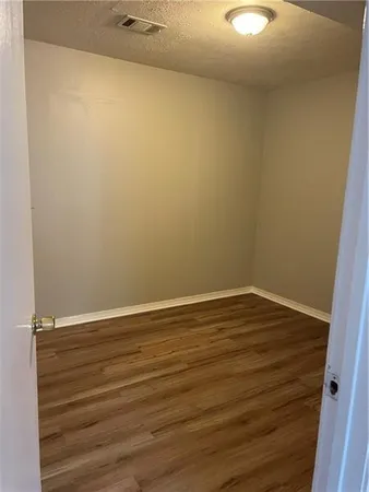 a view of a small space with wooden floor