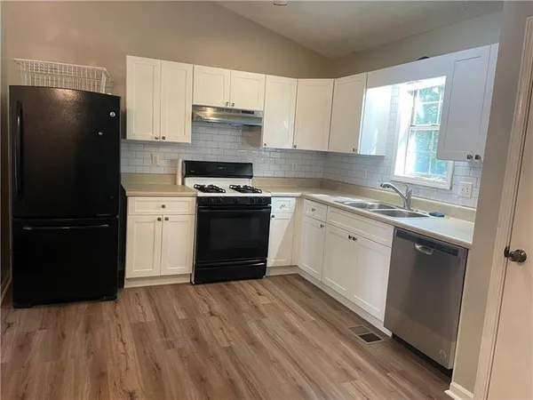 a kitchen with a sink and a stove top oven