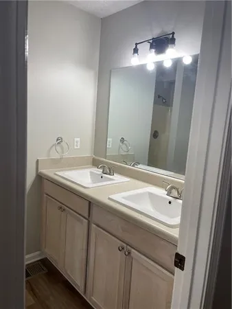a bathroom with a sink double vanity and a mirror