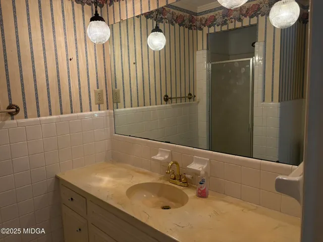 a bathroom with a sink vanity and a mirror