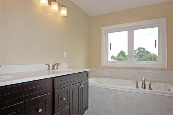 9 Hunt Road Westford, MA 01886 - Photo 8 of 20 a bathroom with a sink a bathtub and a window