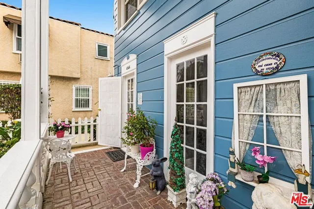 a view of a patio with table and chairs under an umbrella