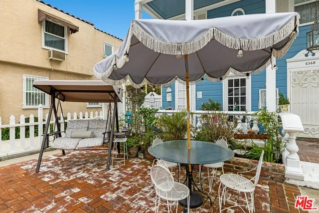 a view of a house with backyard and sitting area