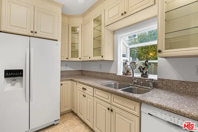 a kitchen with stainless steel appliances granite countertop a sink and a window