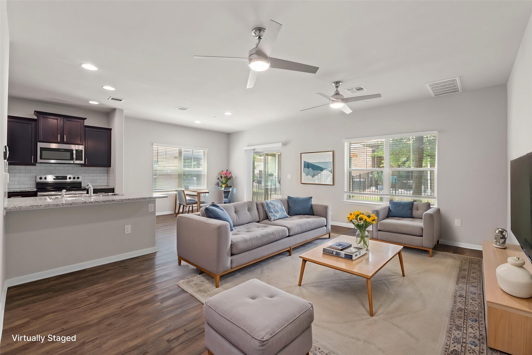 516 East Slaughter Lane, Unit 2001 Austin, TX 78744 - Photo 2 of 31 The open concept living area features hardwood style flooring, recessed lighting, and ceiling fans
