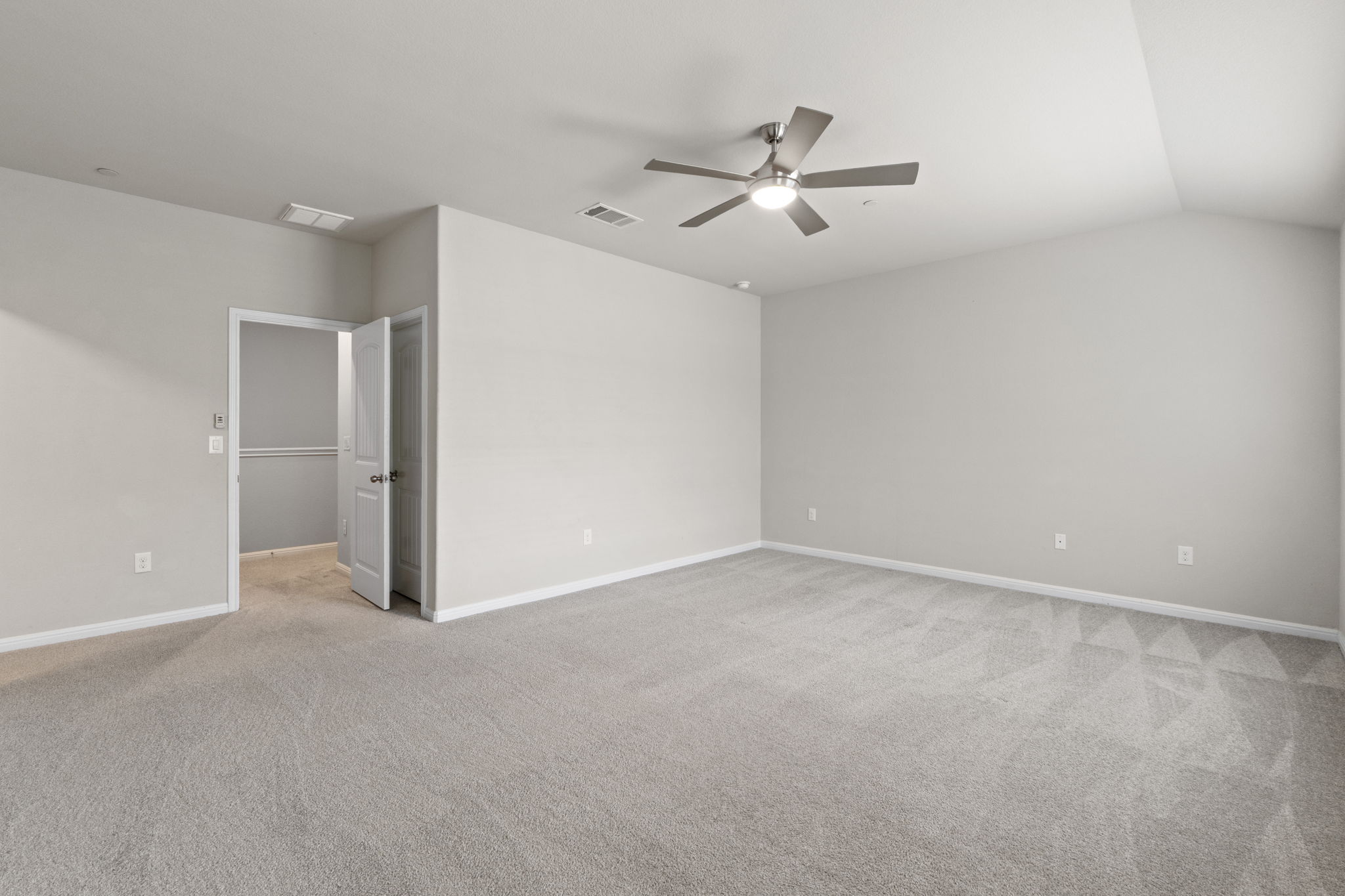 516 East Slaughter Lane, Unit 2001 Austin, TX 78744 - Photo 21 of 31 Spacious room featuring light-colored carpet flooring and a ceiling fan with integrated lighting