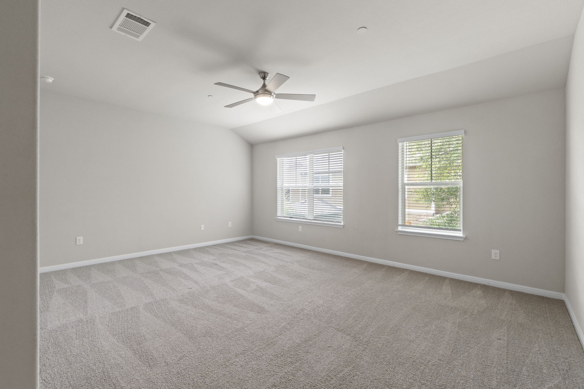 516 East Slaughter Lane, Unit 2001 Austin, TX 78744 - Photo 24 of 31 Spacious room featuring light-colored carpet, white walls, and a ceiling fan with integrated lighting
