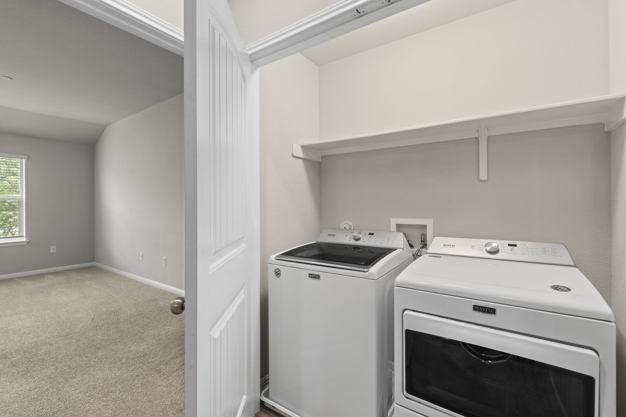 516 East Slaughter Lane, Unit 2001 Austin, TX 78744 - Photo 28 of 31 Convenient laundry area with a white shelf, providing practical storage solutions