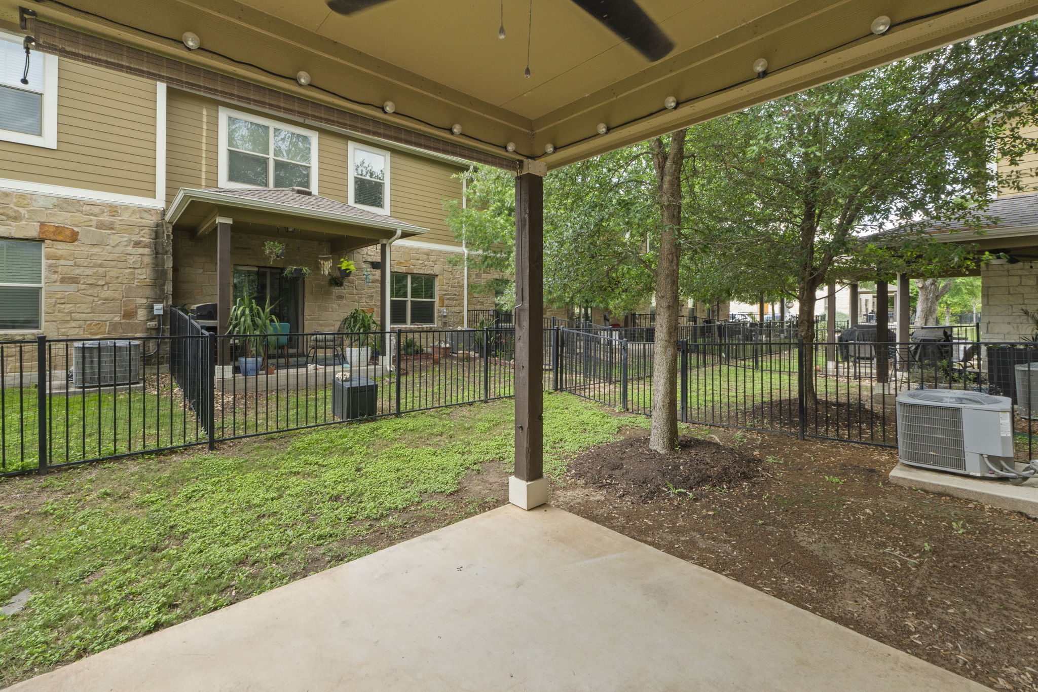 516 East Slaughter Lane, Unit 2001 Austin, TX 78744 - Photo 30 of 31 The property features a private patio with a ceiling fan, offering a comfortable outdoor living space