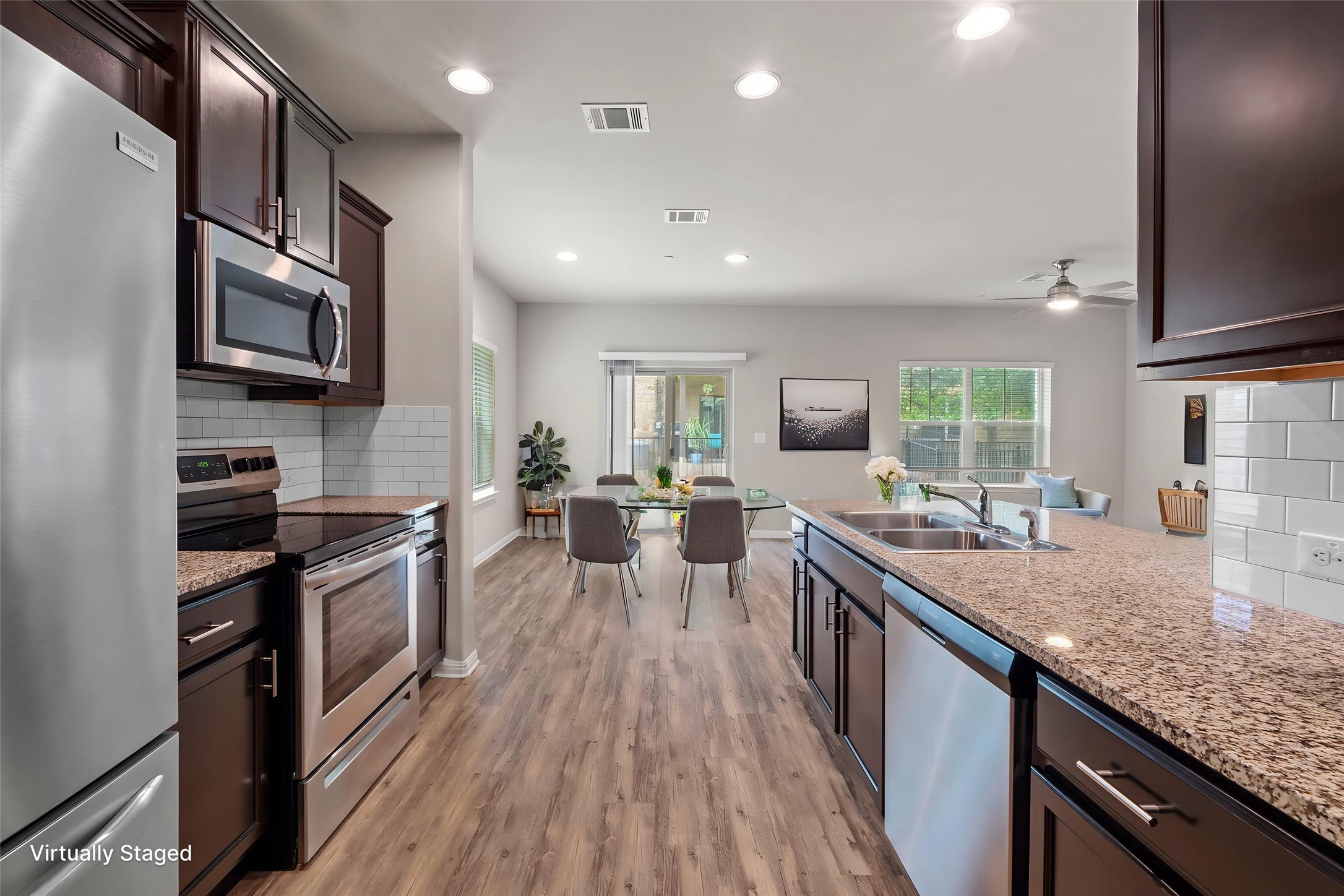 516 East Slaughter Lane, Unit 2001 Austin, TX 78744 - Photo 3 of 31 The kitchen features dark wood cabinetry, granite countertops, and stainless steel appliances