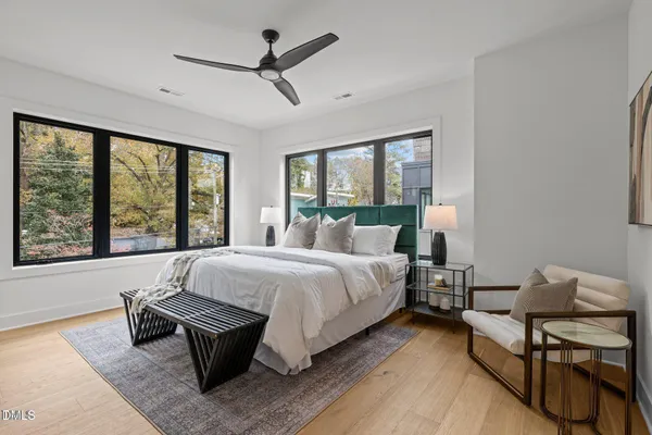 a bed room with a bed and a chair