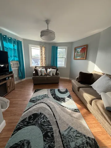 a bedroom with a bed window and couch