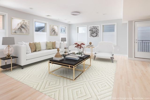 a living room with furniture and wooden floor
