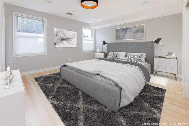 a bedroom with bed and a window