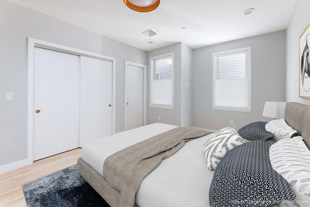 a bedroom with a bed and a window