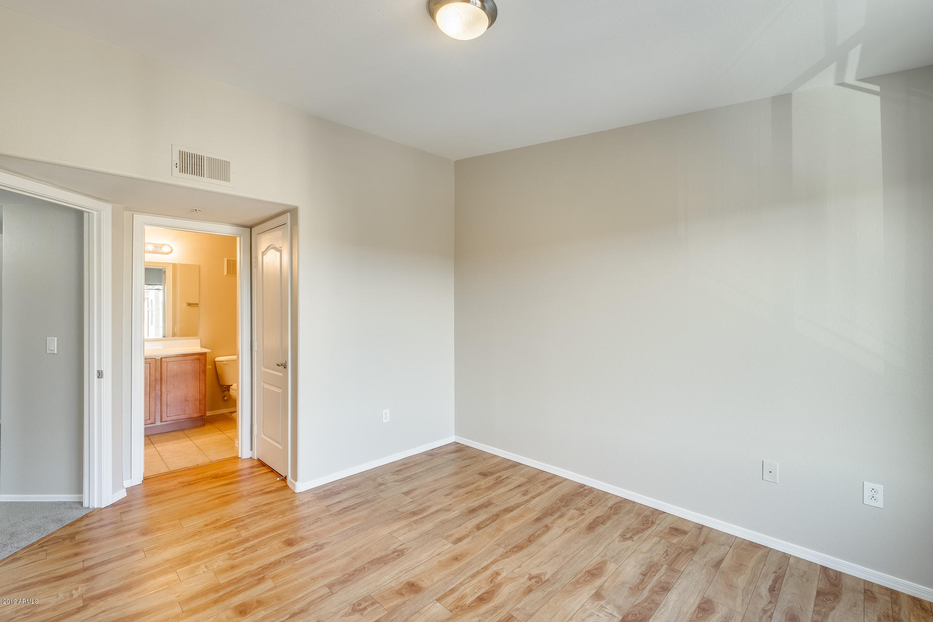 2401 East Rio Salado Parkway, Unit 1124 Tempe, AZ 85288 - Photo 30 of 32 a view of empty room with wooden floor and fan