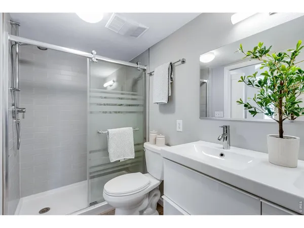 a bedroom with a bed table and a window