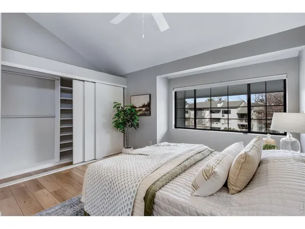 a bedroom with a bed and a potted plant