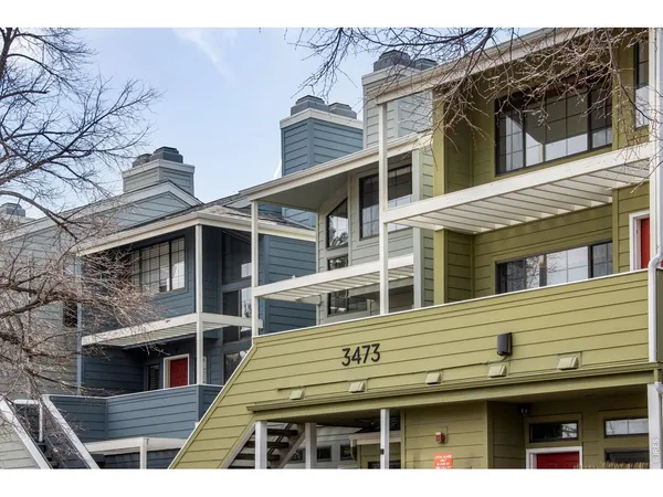 a view of a house with a balcony and wooden floor
