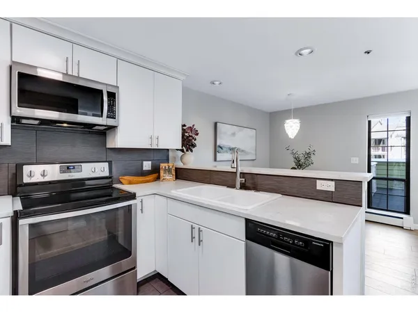 a kitchen with a sink stove and microwave