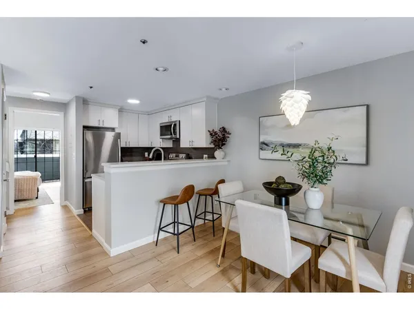 a view of kitchen with refrigerator dining table and chairs