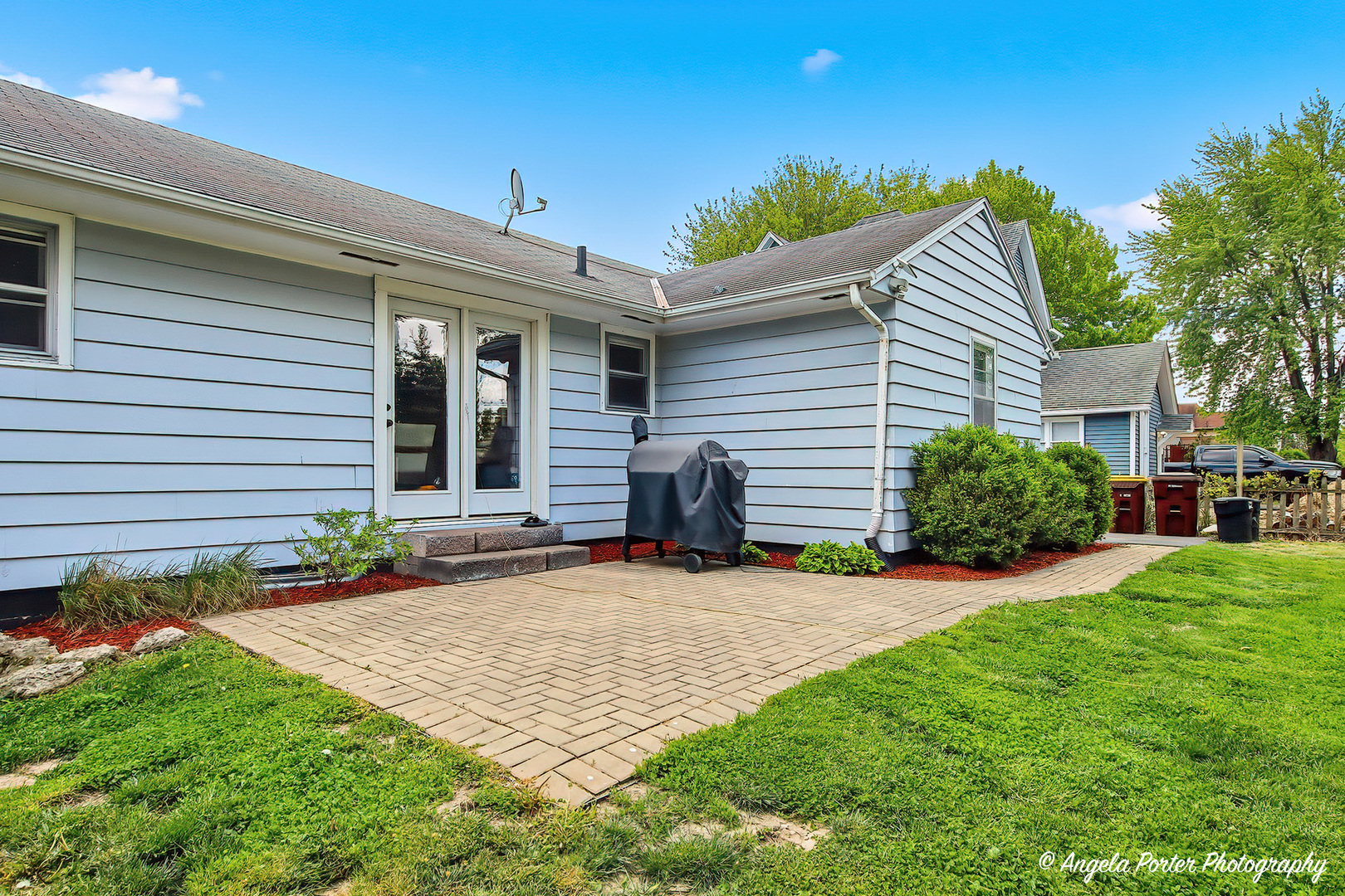 353 Marengo Road Harvard, IL 60033 - Photo 19 of 23 a front view of a house with a yard and potted plants